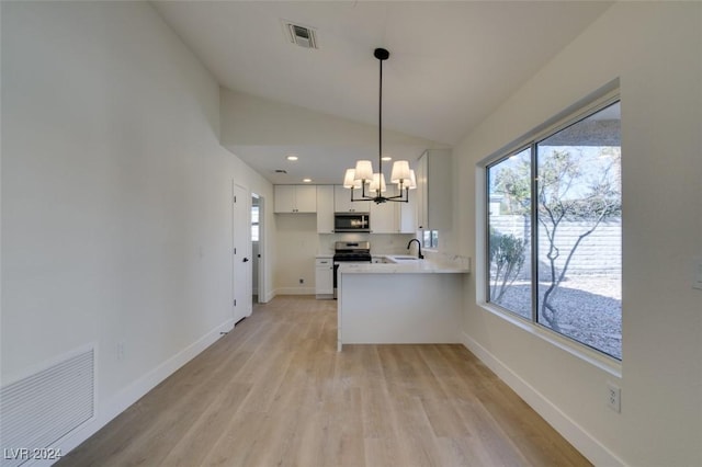 kitchen with kitchen peninsula, sink, pendant lighting, white cabinets, and lofted ceiling