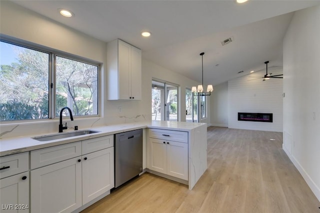 kitchen featuring kitchen peninsula, light wood-type flooring, stainless steel dishwasher, sink, and white cabinetry