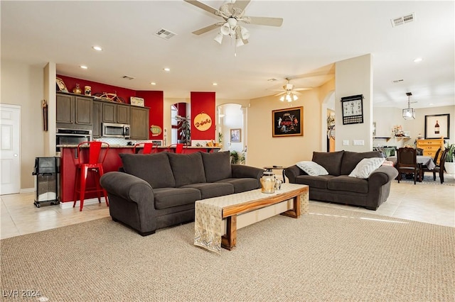 living room featuring ceiling fan and light tile patterned floors