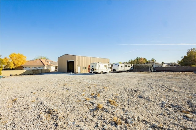 back of property featuring an outbuilding and a garage