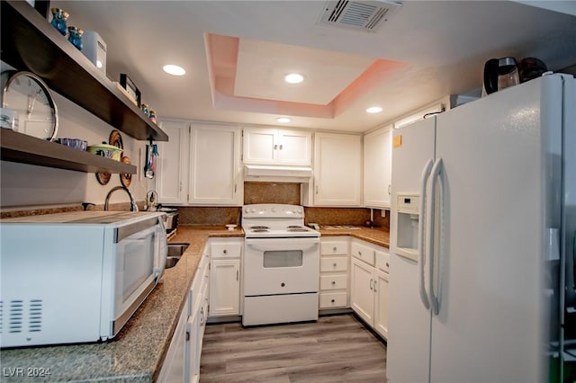 1701 E Katie Ave Unit 72, Las Vegas, NV 89119 - kitchen with white appliances, custom exhaust hood, recessed lighting, tasteful backsplash, and white cabinetry