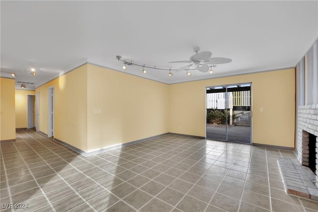 unfurnished living room with a fireplace, tile patterned floors, ceiling fan, and crown molding