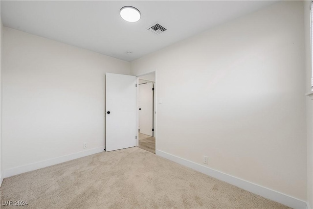 empty room with light colored carpet