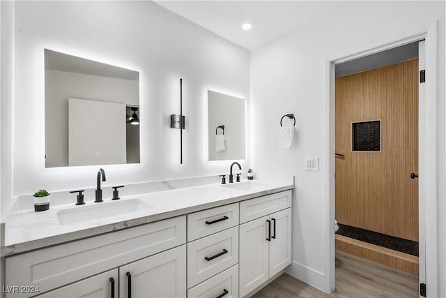 bathroom with hardwood / wood-style floors and vanity