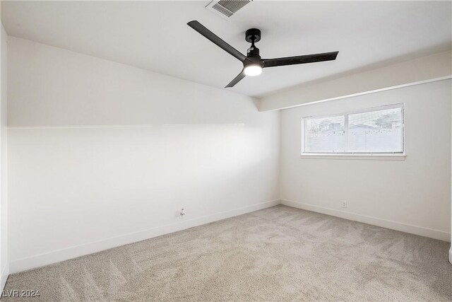 unfurnished room featuring ceiling fan and light colored carpet