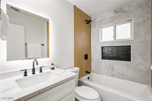 full bathroom featuring vanity, toilet, and tiled shower / bath combo