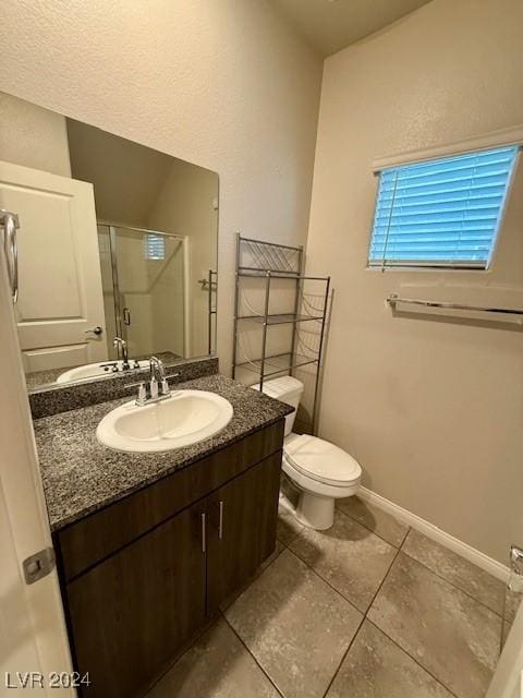 bathroom featuring an enclosed shower, vanity, tile patterned flooring, and toilet