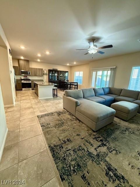 tiled living room featuring ceiling fan