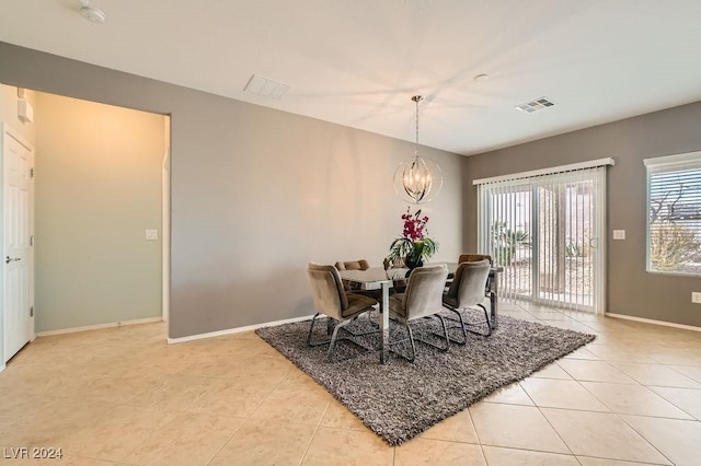 tiled dining area with a notable chandelier