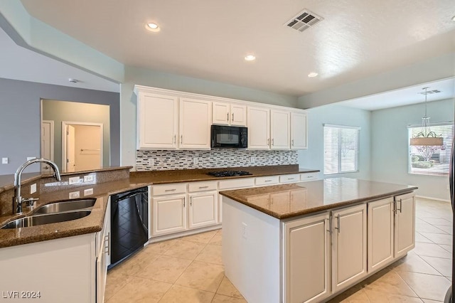 kitchen with white cabinetry, sink, decorative light fixtures, light tile patterned floors, and black appliances