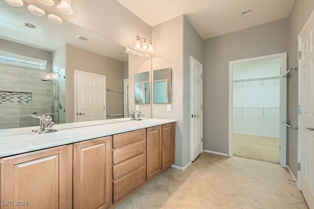 bathroom featuring tile patterned flooring, vanity, and a shower with shower door