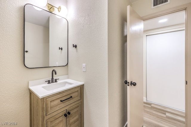 bathroom with vanity and hardwood / wood-style flooring