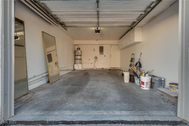 garage featuring water heater and a garage door opener