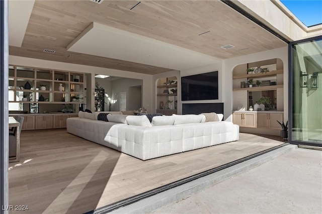 living room featuring built in features, wood ceiling, visible vents, and wood finished floors