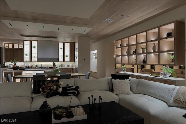 living room featuring wooden ceiling and visible vents