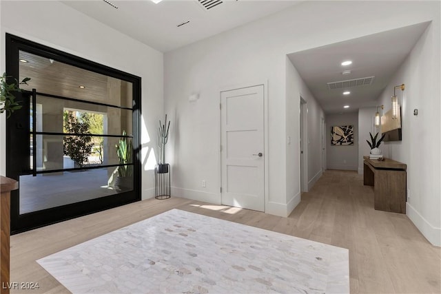 entryway featuring recessed lighting, wood finished floors, visible vents, and baseboards