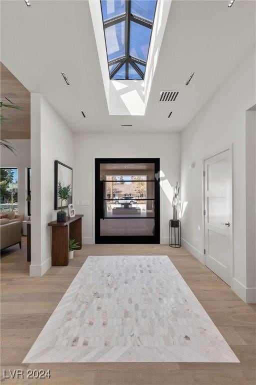 interior space featuring light wood-style floors, visible vents, and a healthy amount of sunlight