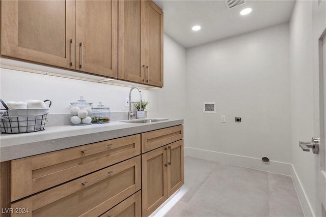 clothes washing area featuring hookup for a washing machine, hookup for an electric dryer, a sink, visible vents, and baseboards