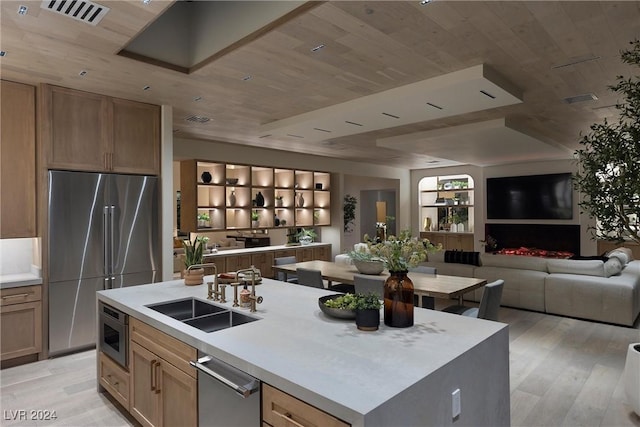 kitchen with a center island with sink, visible vents, appliances with stainless steel finishes, open floor plan, and wooden ceiling