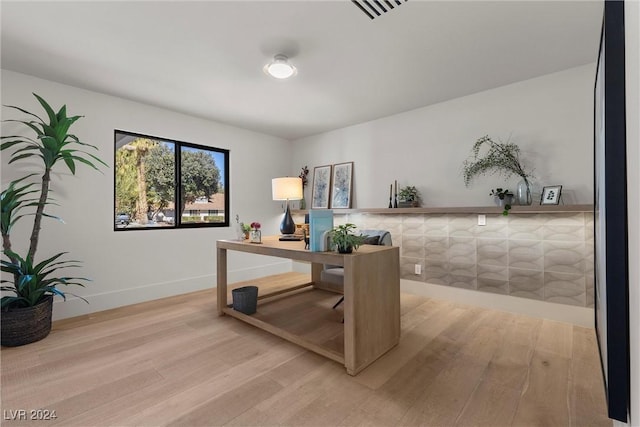 home office with visible vents, baseboards, and wood finished floors