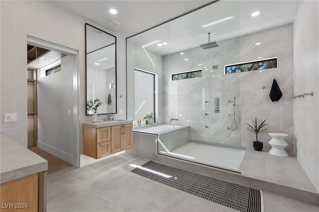 bathroom featuring a walk in shower, recessed lighting, vanity, and a bath