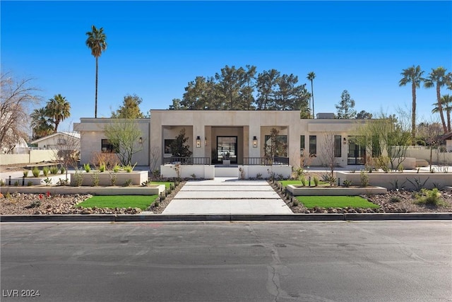 view of front of home featuring a fenced front yard and stucco siding