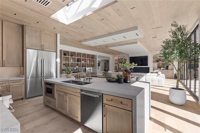 kitchen featuring wooden ceiling, open floor plan, light countertops, appliances with stainless steel finishes, and light wood-type flooring