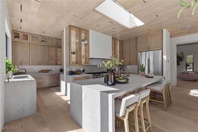 kitchen featuring wood ceiling, visible vents, and stainless steel refrigerator