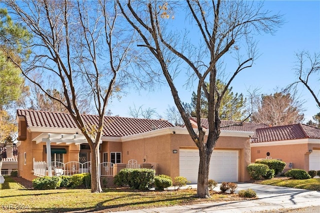 mediterranean / spanish-style house featuring covered porch, a garage, and a front lawn