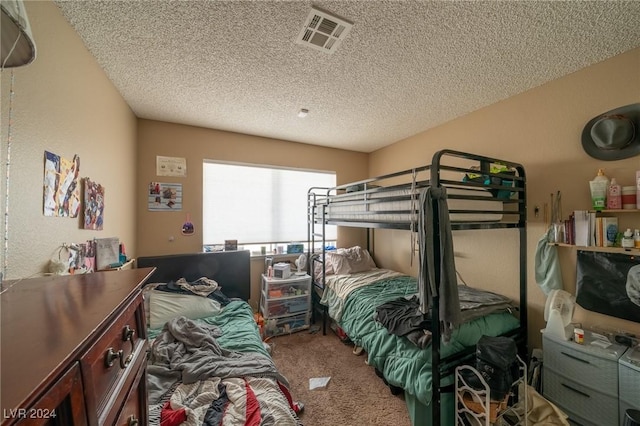 bedroom featuring carpet and a textured ceiling