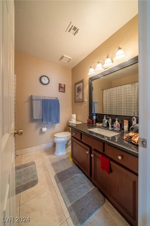 bathroom featuring tile patterned floors, vanity, and toilet