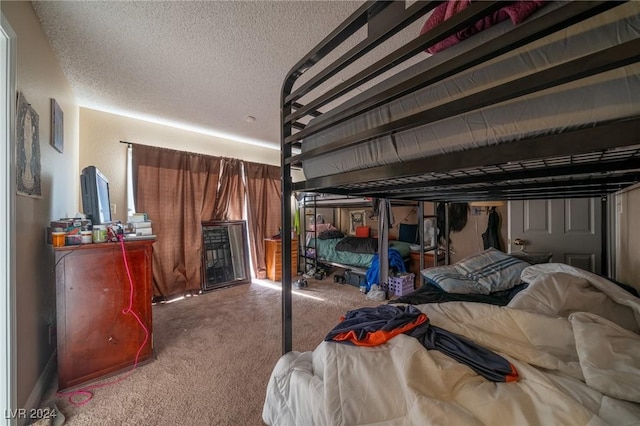 carpeted bedroom with a textured ceiling