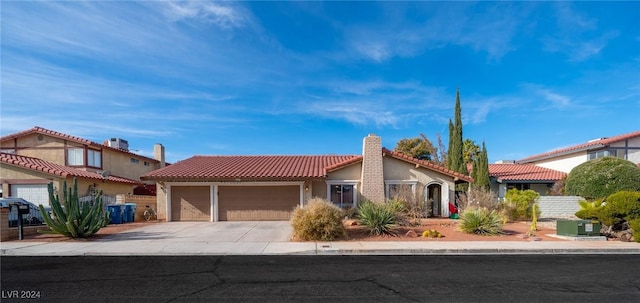 mediterranean / spanish house featuring a garage