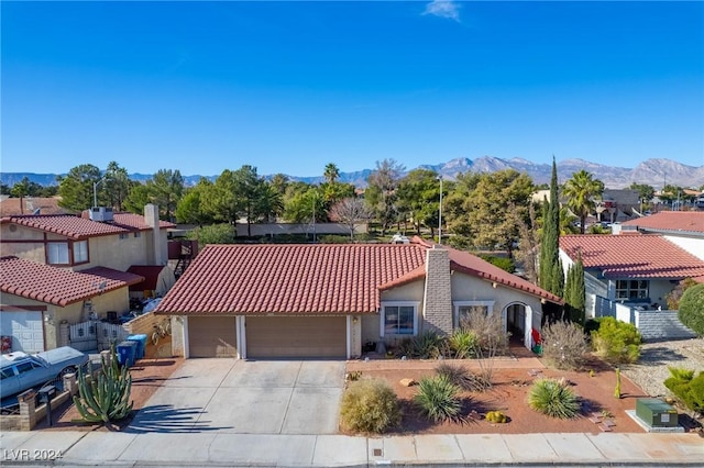 view of front of home with a mountain view and a garage