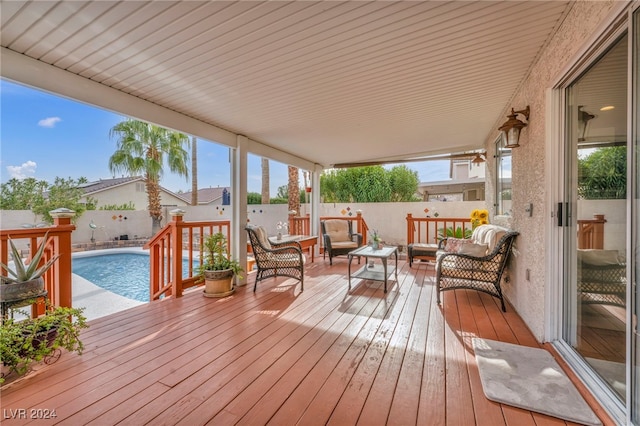 wooden deck featuring a fenced in pool and outdoor lounge area