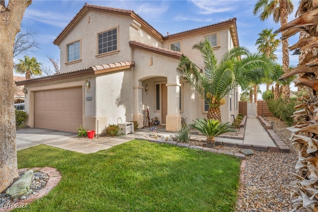 mediterranean / spanish-style home featuring a front lawn and a garage