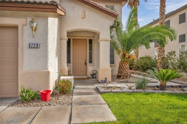 doorway to property with a garage