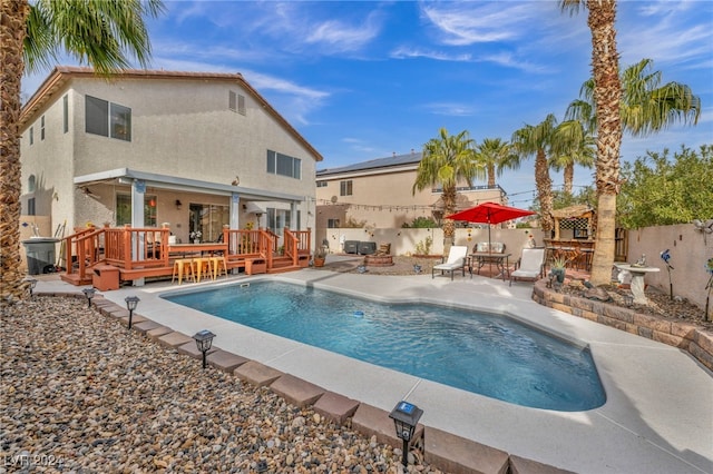 view of pool with a patio area, a deck, and a fire pit