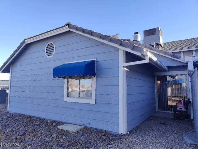 view of side of property featuring central AC