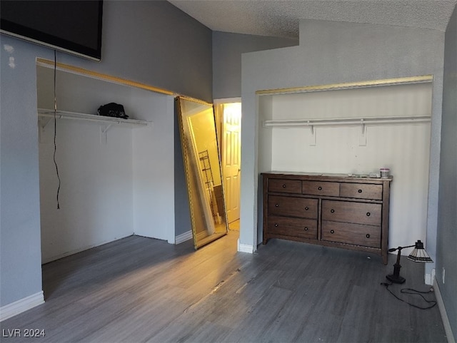 unfurnished bedroom featuring hardwood / wood-style floors, a textured ceiling, and a closet