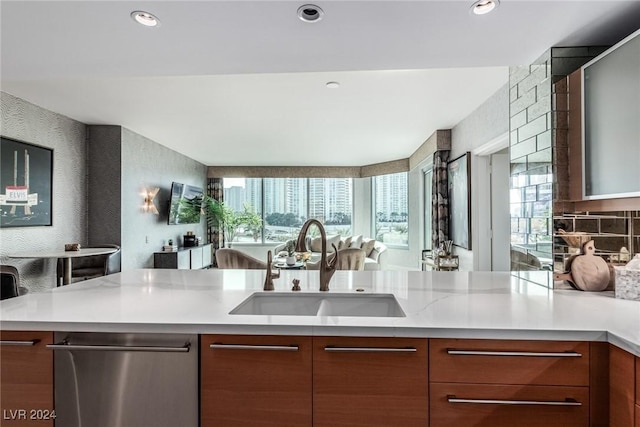 kitchen featuring dishwasher, kitchen peninsula, a healthy amount of sunlight, and sink