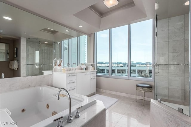 bathroom featuring vanity, separate shower and tub, and a raised ceiling