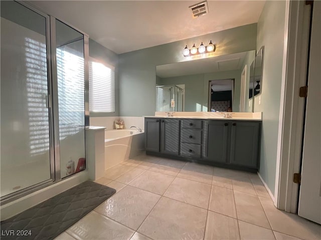 bathroom with tile patterned flooring, vanity, and shower with separate bathtub