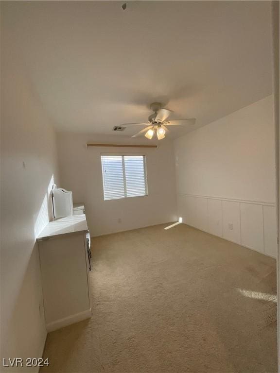 carpeted empty room with ceiling fan