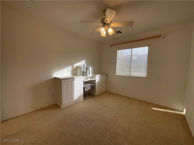 interior space with light colored carpet and ceiling fan