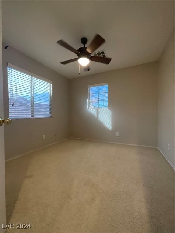 unfurnished room with light carpet, ceiling fan, and a healthy amount of sunlight