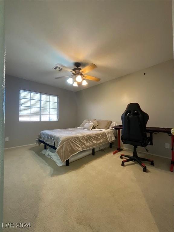 bedroom with ceiling fan and light colored carpet