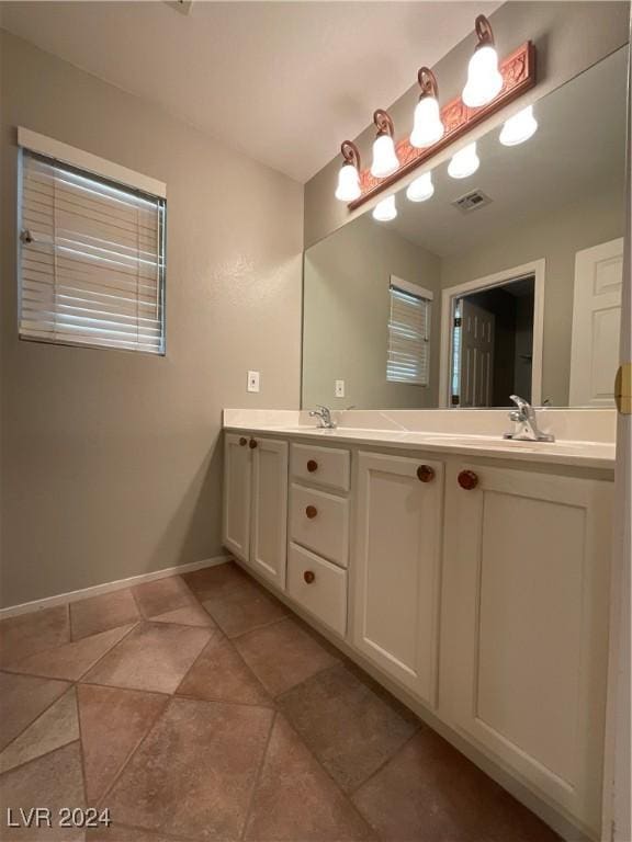 bathroom featuring tile patterned flooring and vanity