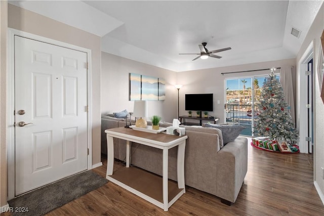 living room with dark hardwood / wood-style floors and ceiling fan