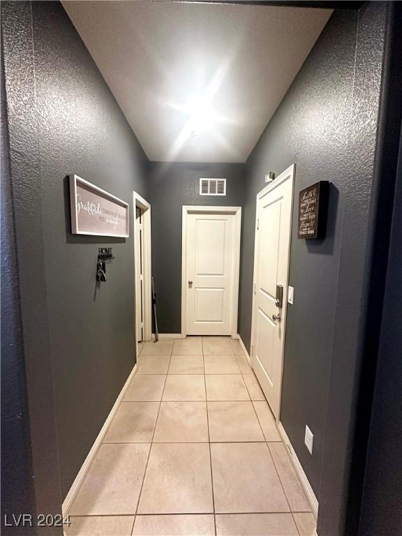 hall with light tile patterned flooring